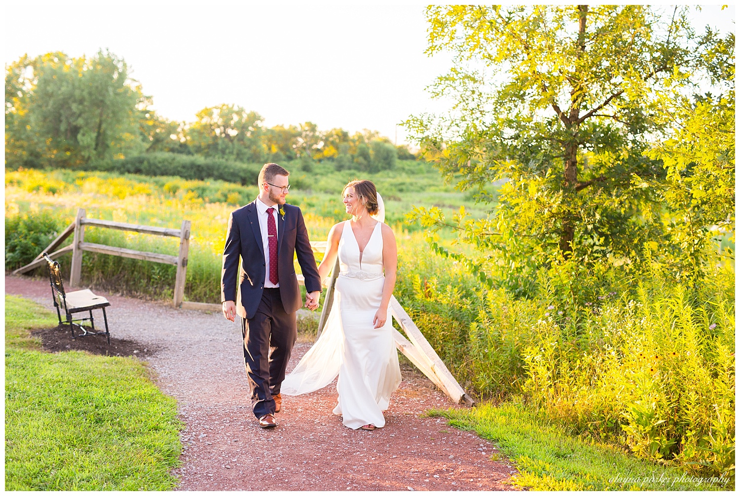 bride and groom walking down path at grange insurance audubon center