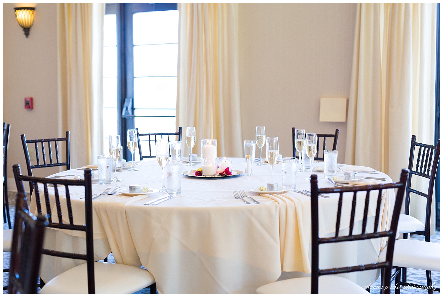 simple white tablecloth and white and black chairs for reception at club at corazon