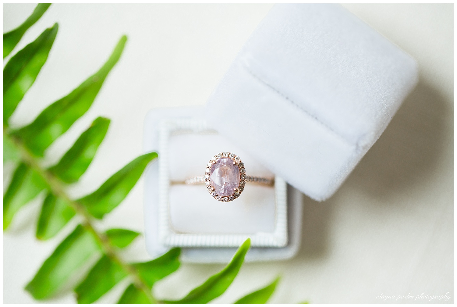 rose gold and pink sapphire engagement ring in white velvet ring box