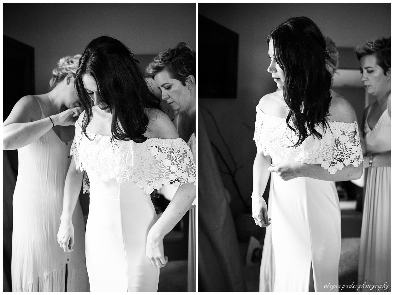 black and white image of bride getting wedding dress on