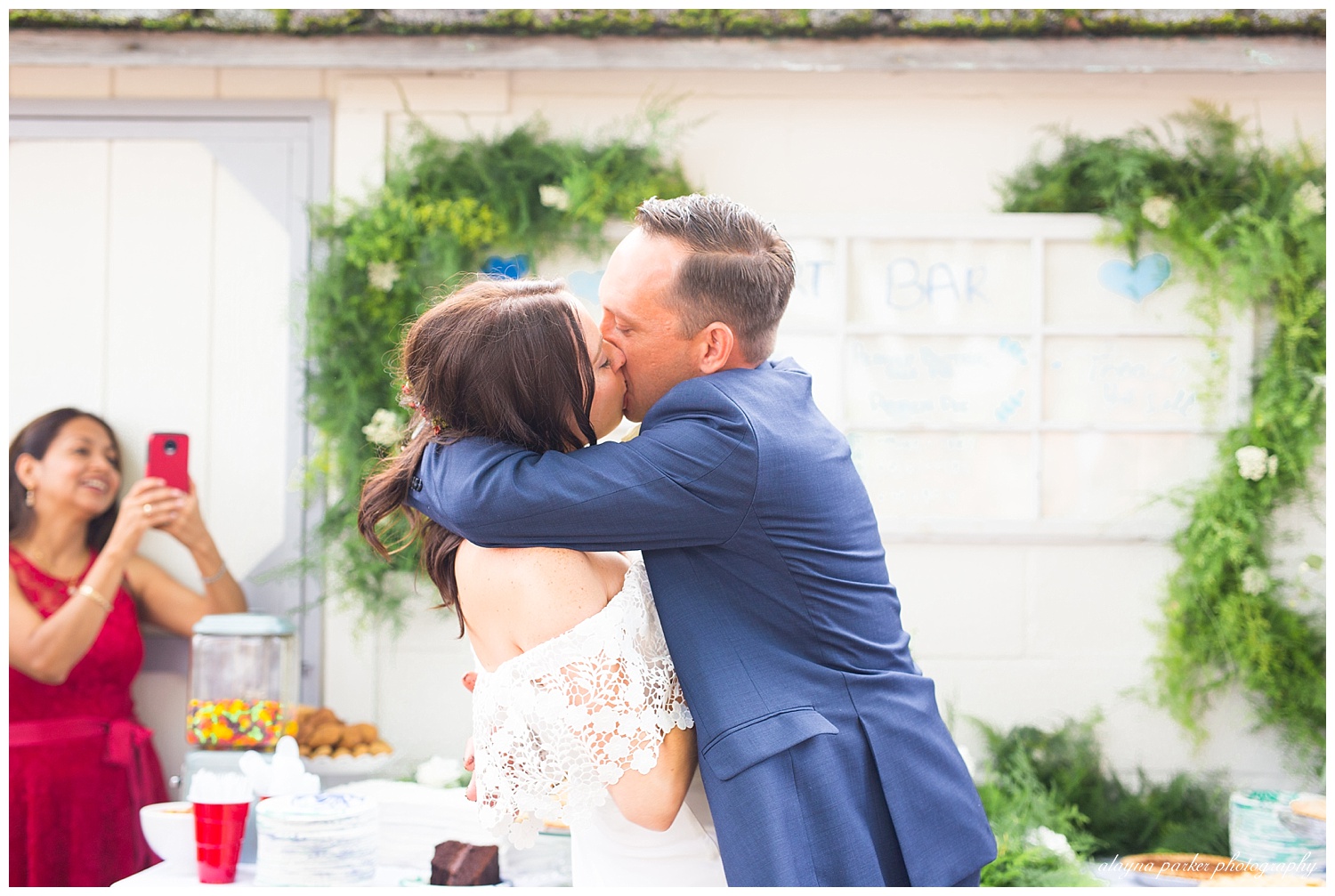 bride and groom kissing after cutting cake