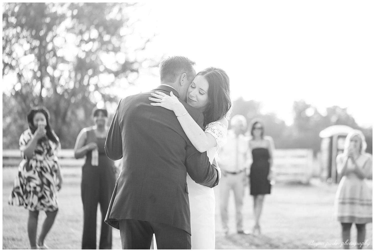 black and white image of bride and groom sharing first dance