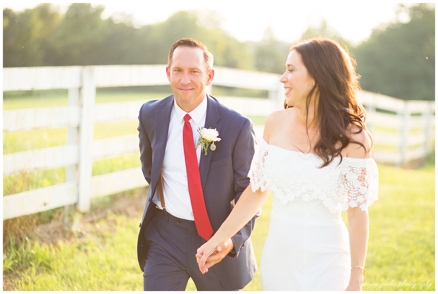 groom smiling at camera as bride is walking beside him