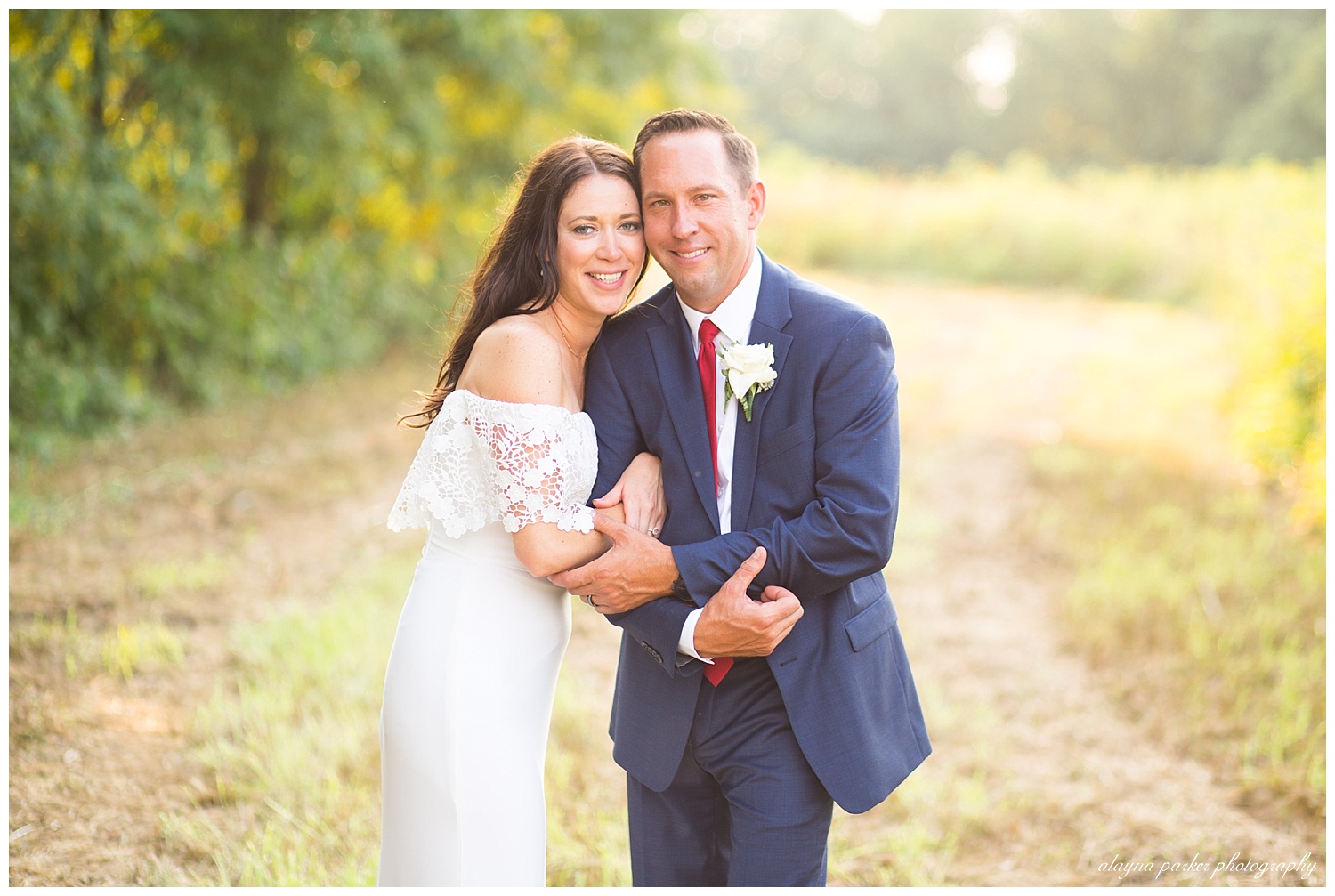 bride and groom smiling at camera during golden hour