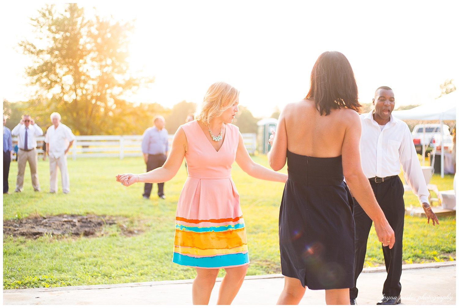 guests dancing outside at wedding