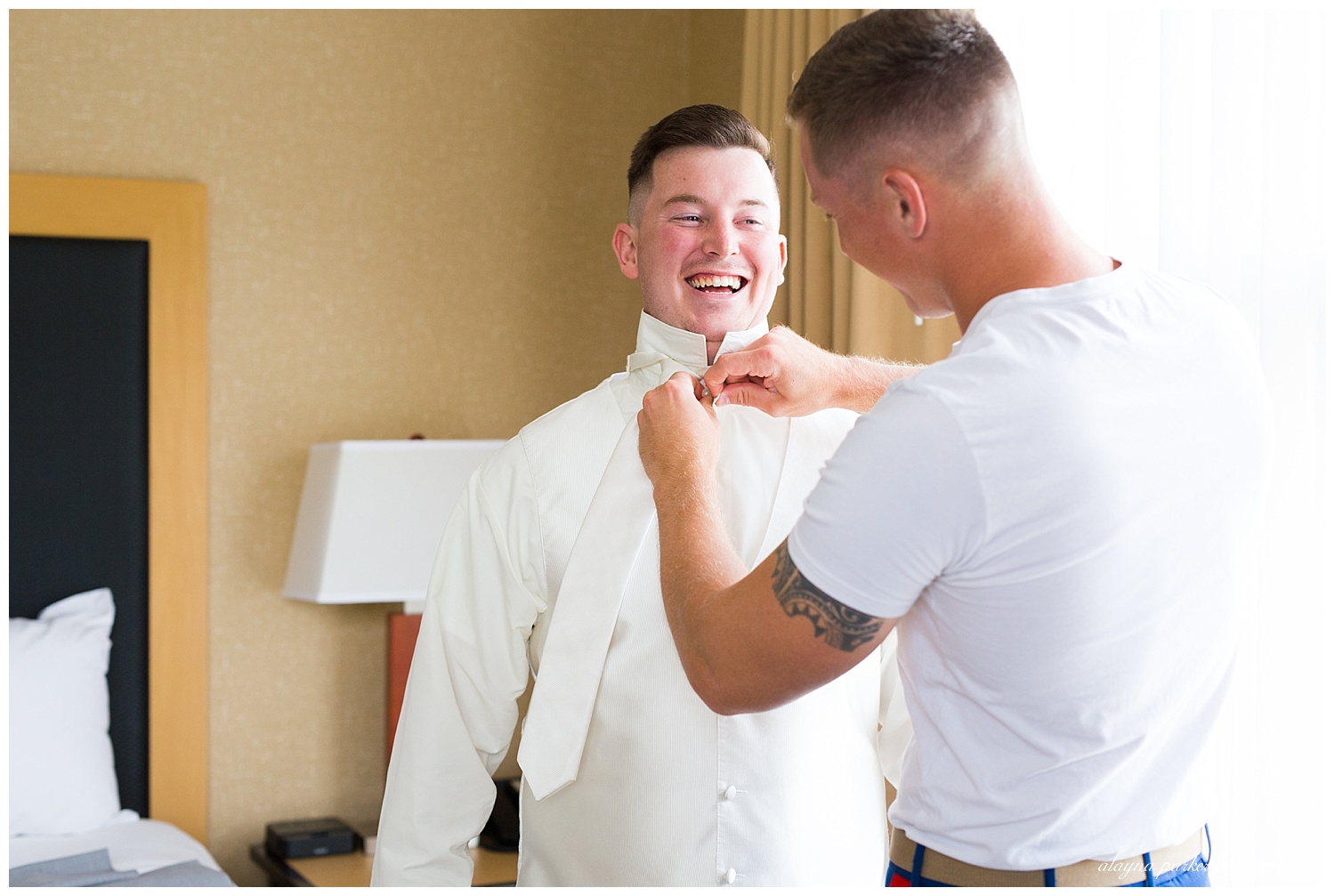 best man tying groom's tie