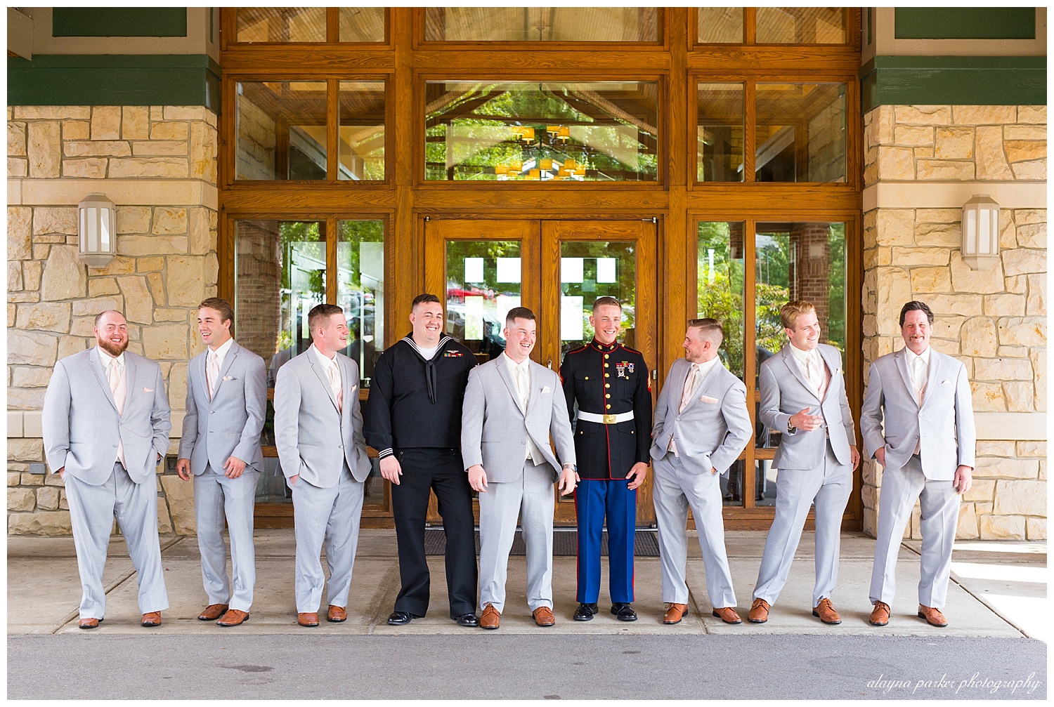 groom and groomsmen laughing in front of south pointe golf club