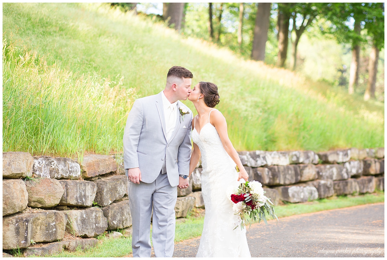 bride and groom stopping for a kiss at south pointe golf club