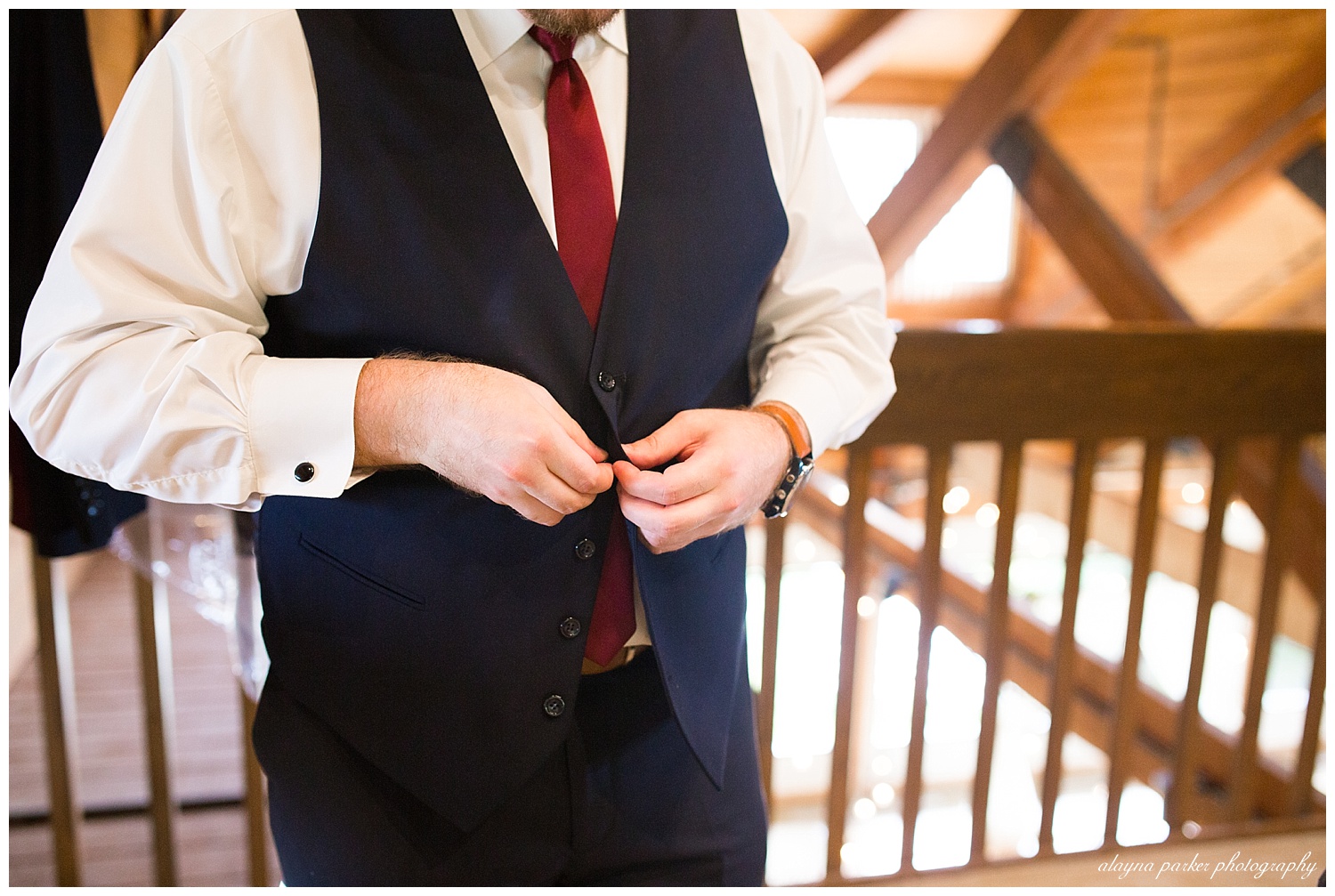 groom buttoning vest