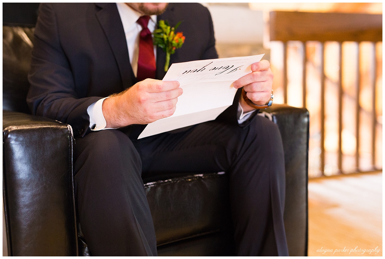 close up of groom reading letter from bride
