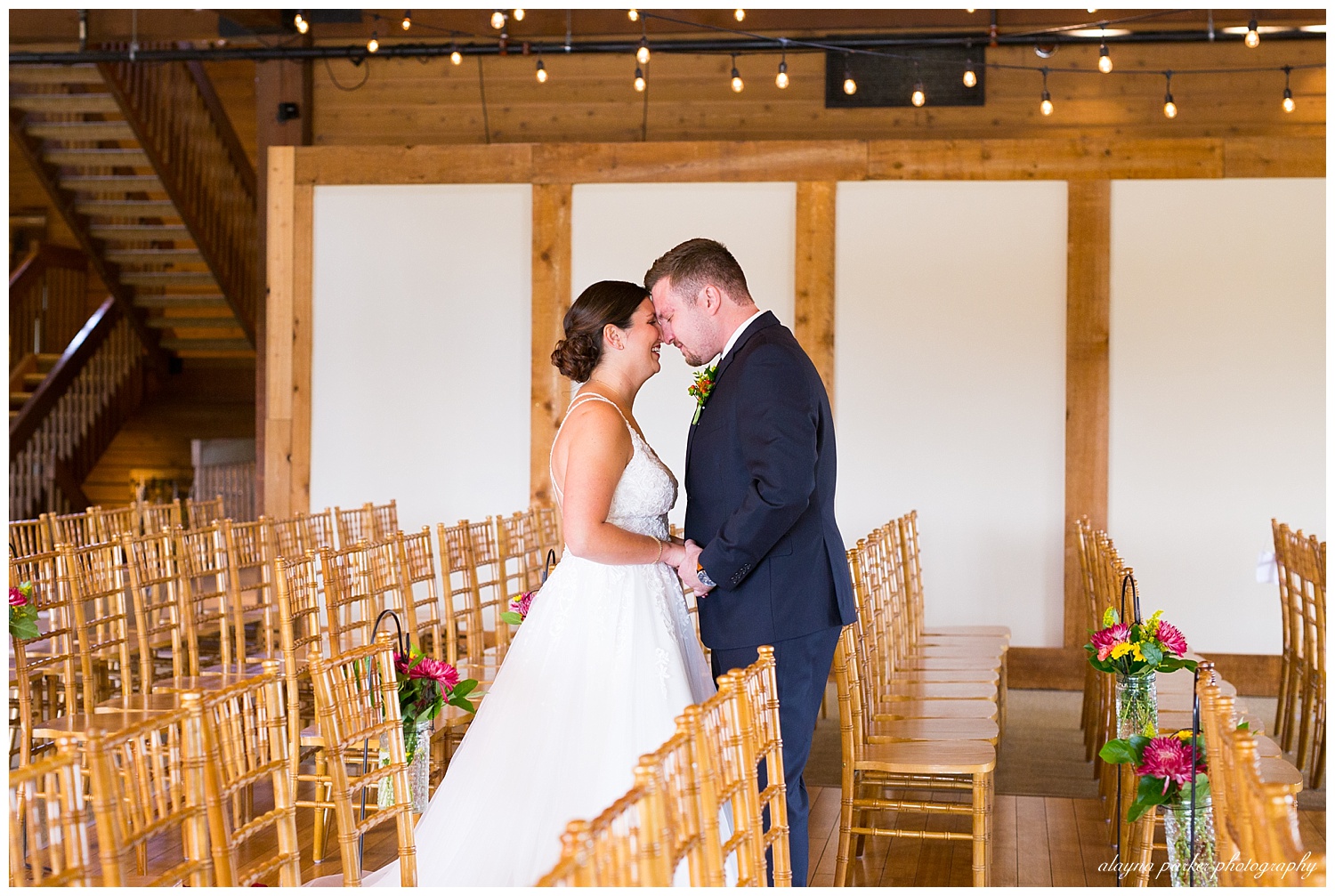bride and groom seeing each other in empty ceremony space for the first time at water's edge