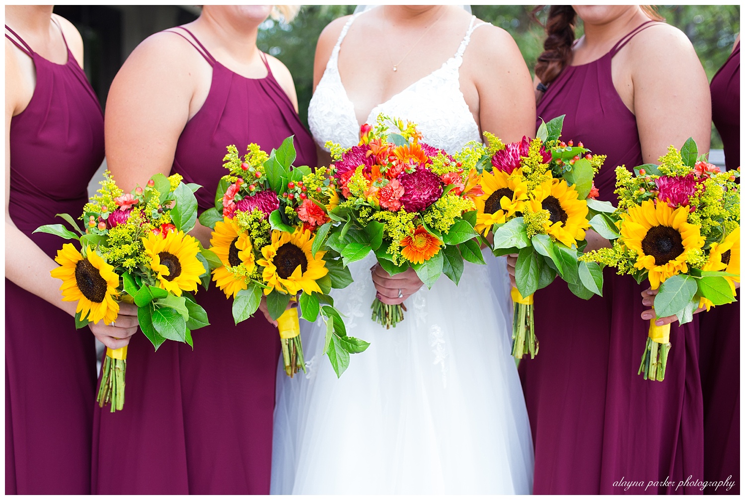 close up of vibrant bouquets with sunflowers, pink flowers, and orange flowers