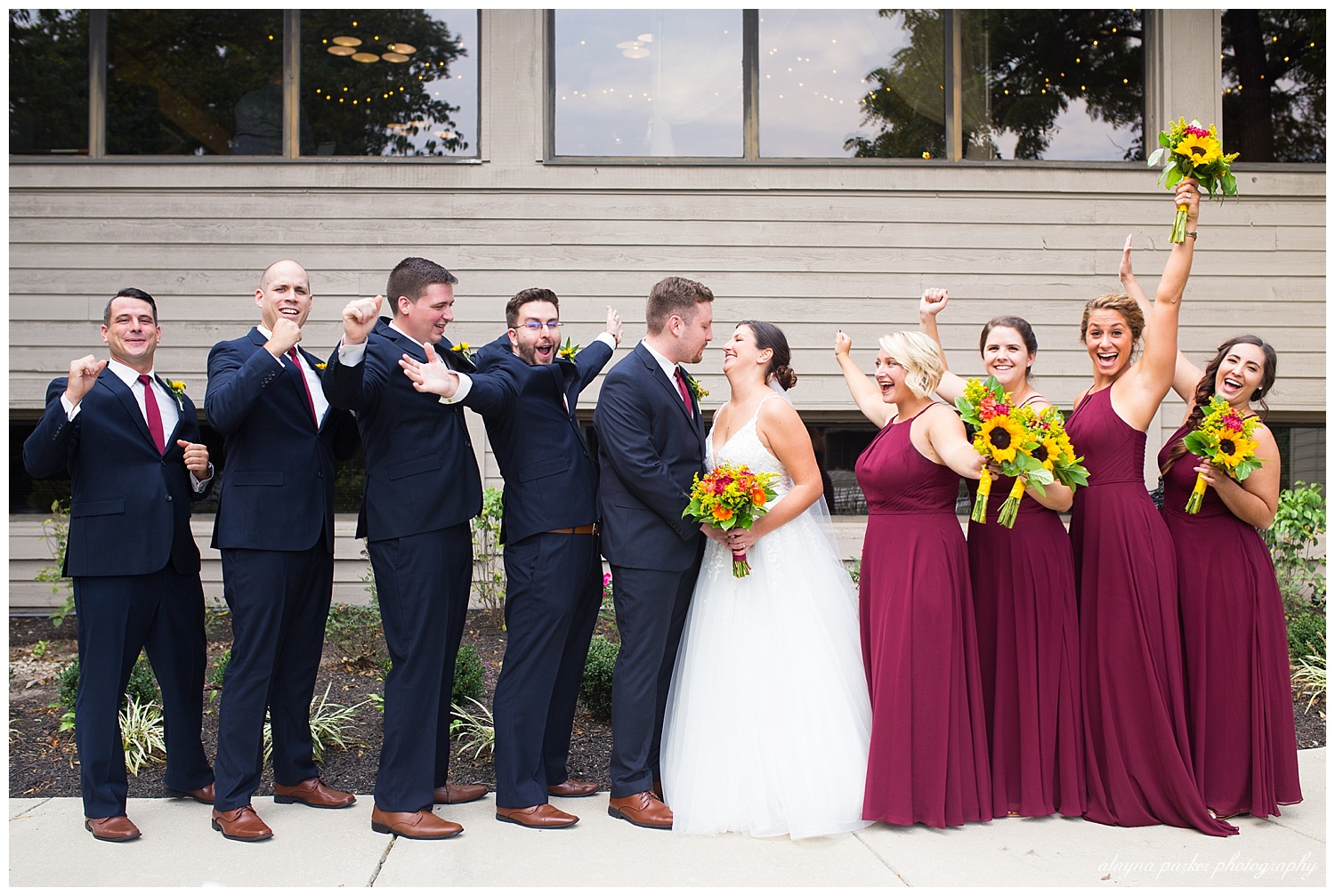 bridal party cheering for bride and groom