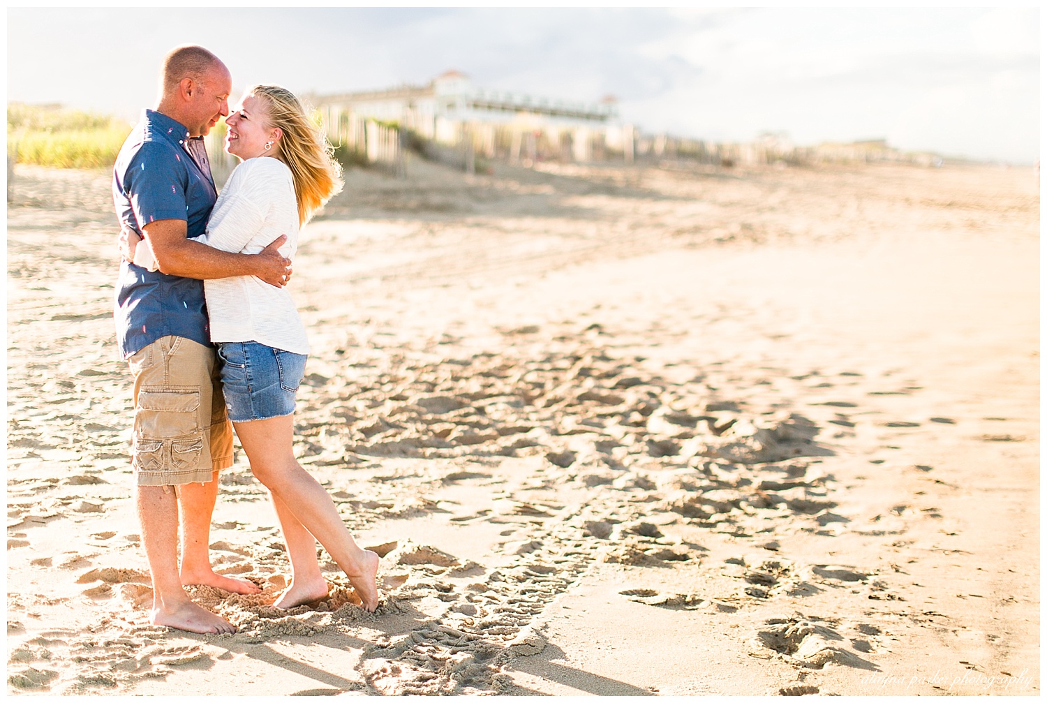 couple smiling at each other on outer banks beach
