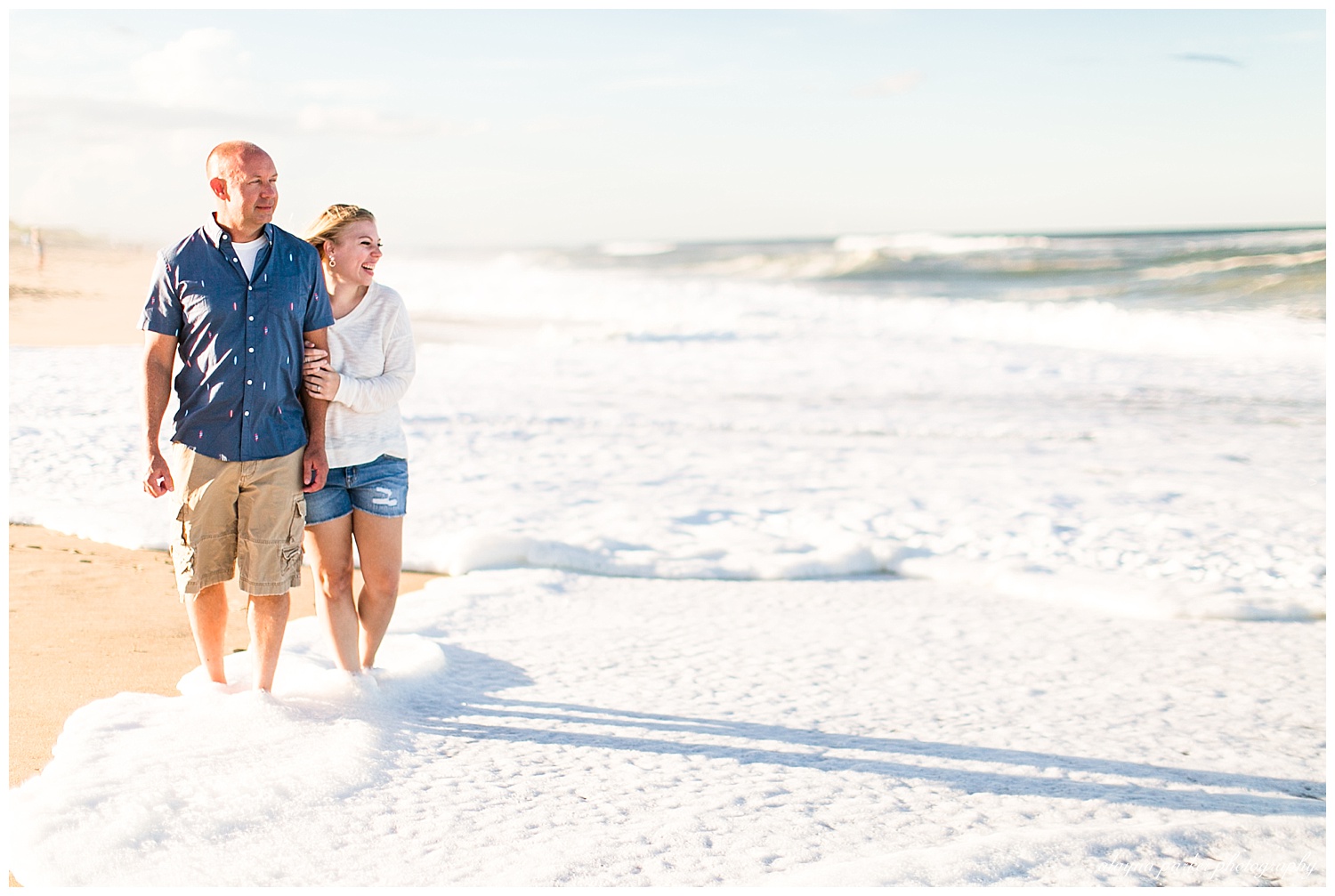 couple looking at ocean on beach in outer banks