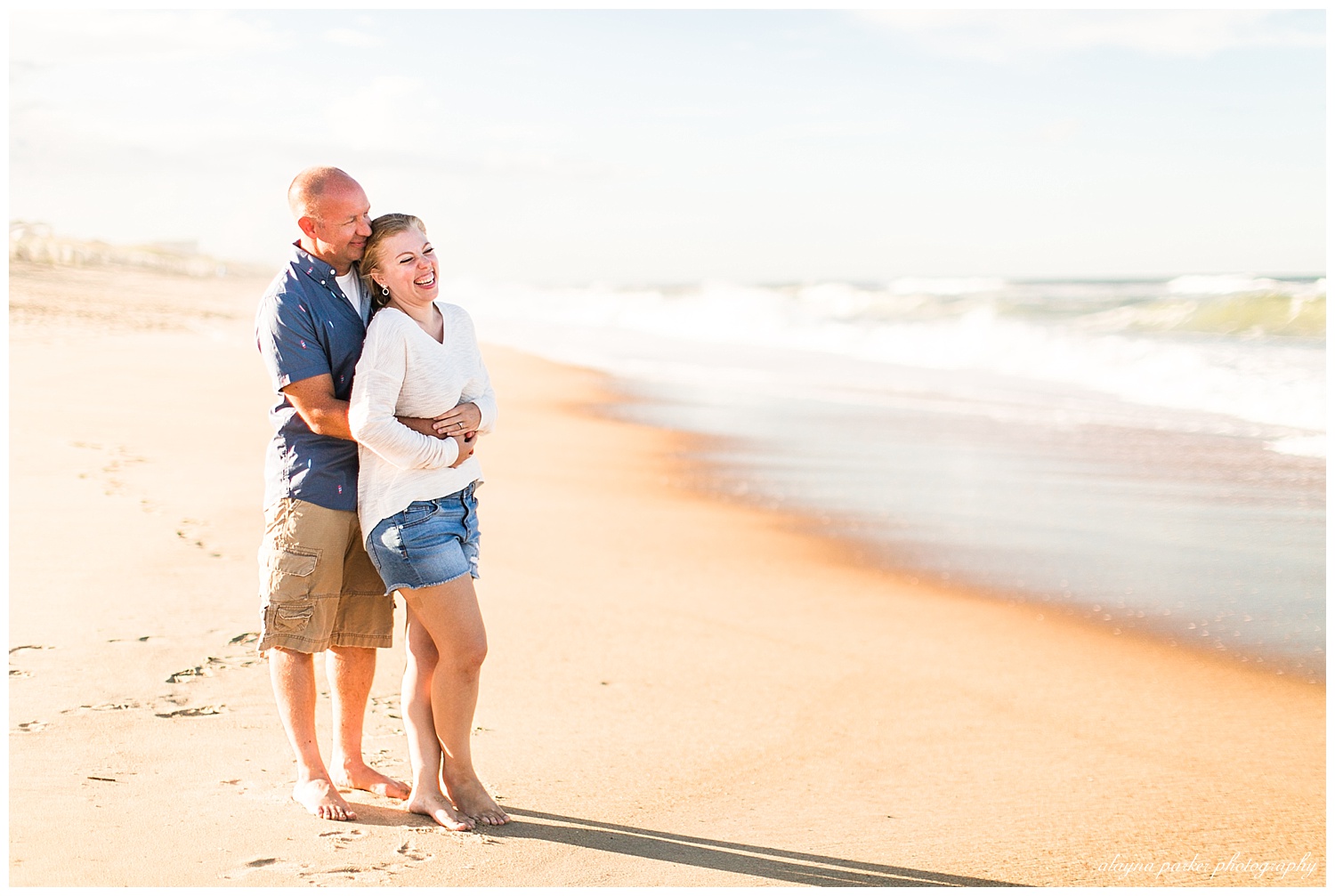 couple hugging on beach in outer banks