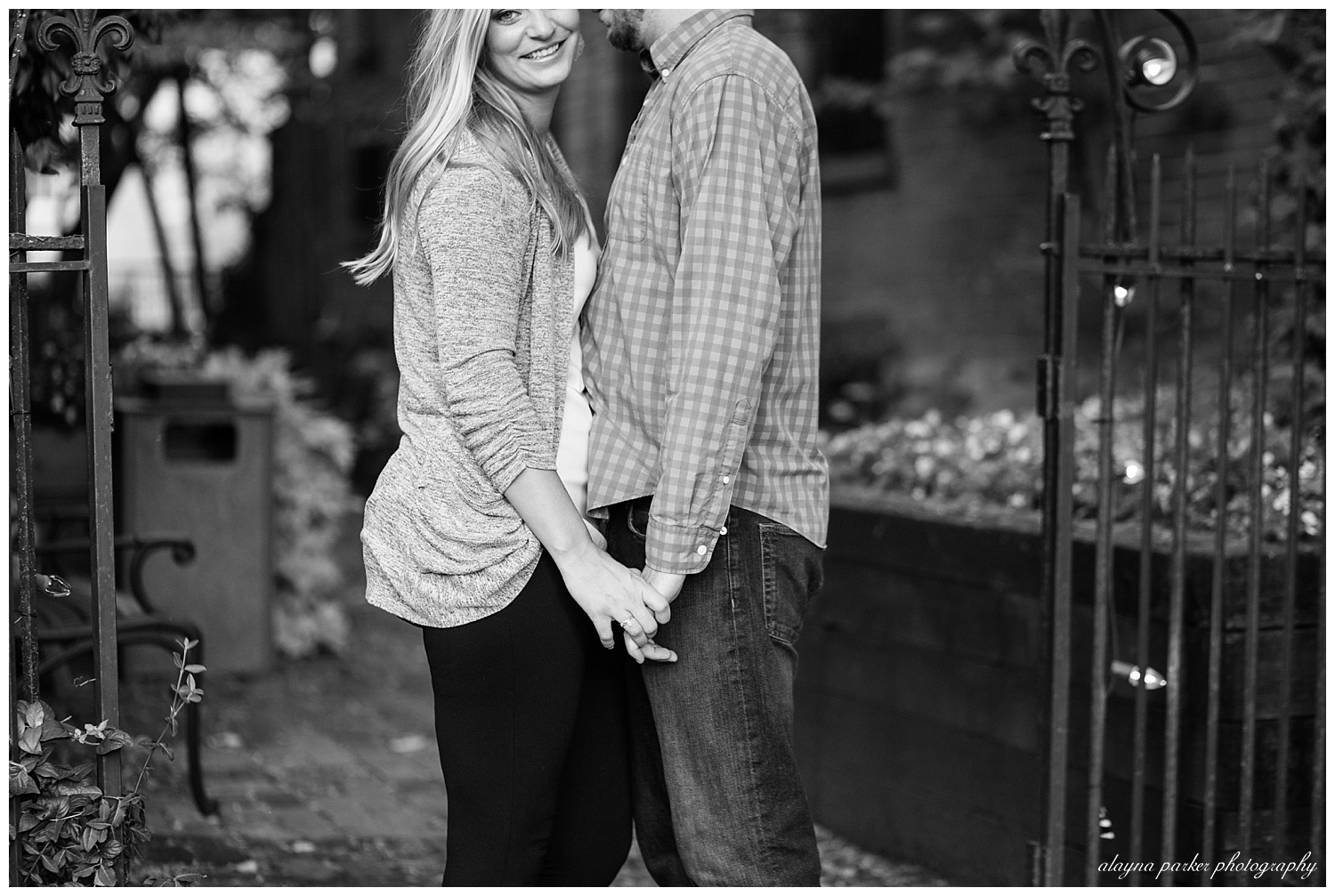 black and white image of man and woman holding hands in german village