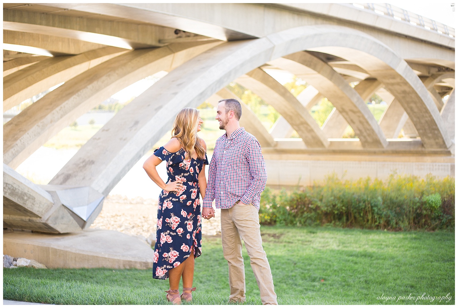 man and woman smiling at each other by bridge at scioto mile
