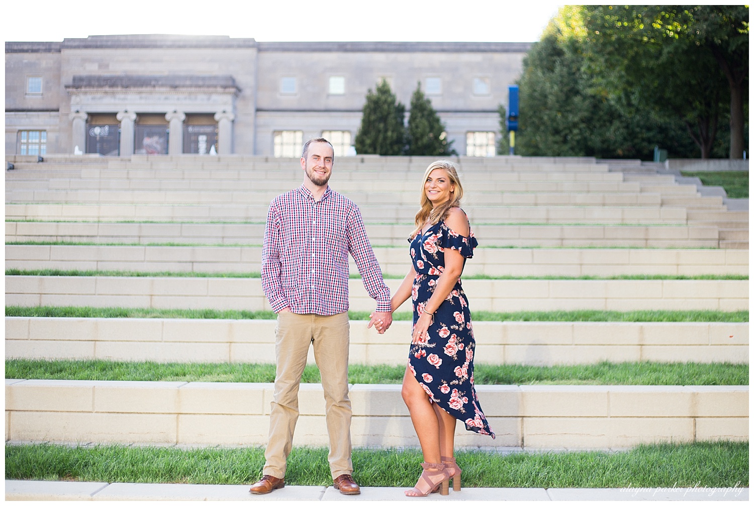 man and woman holding hands and smiling at the camera on steps at scioto mile