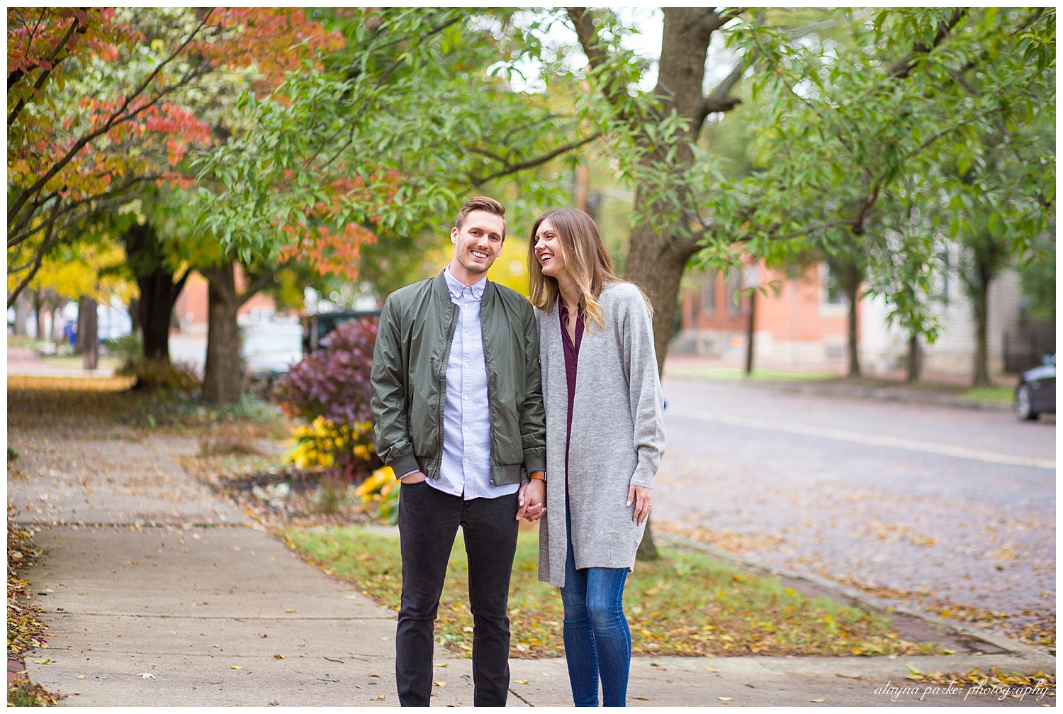 woman laughing at man while he looks at the camera in german village