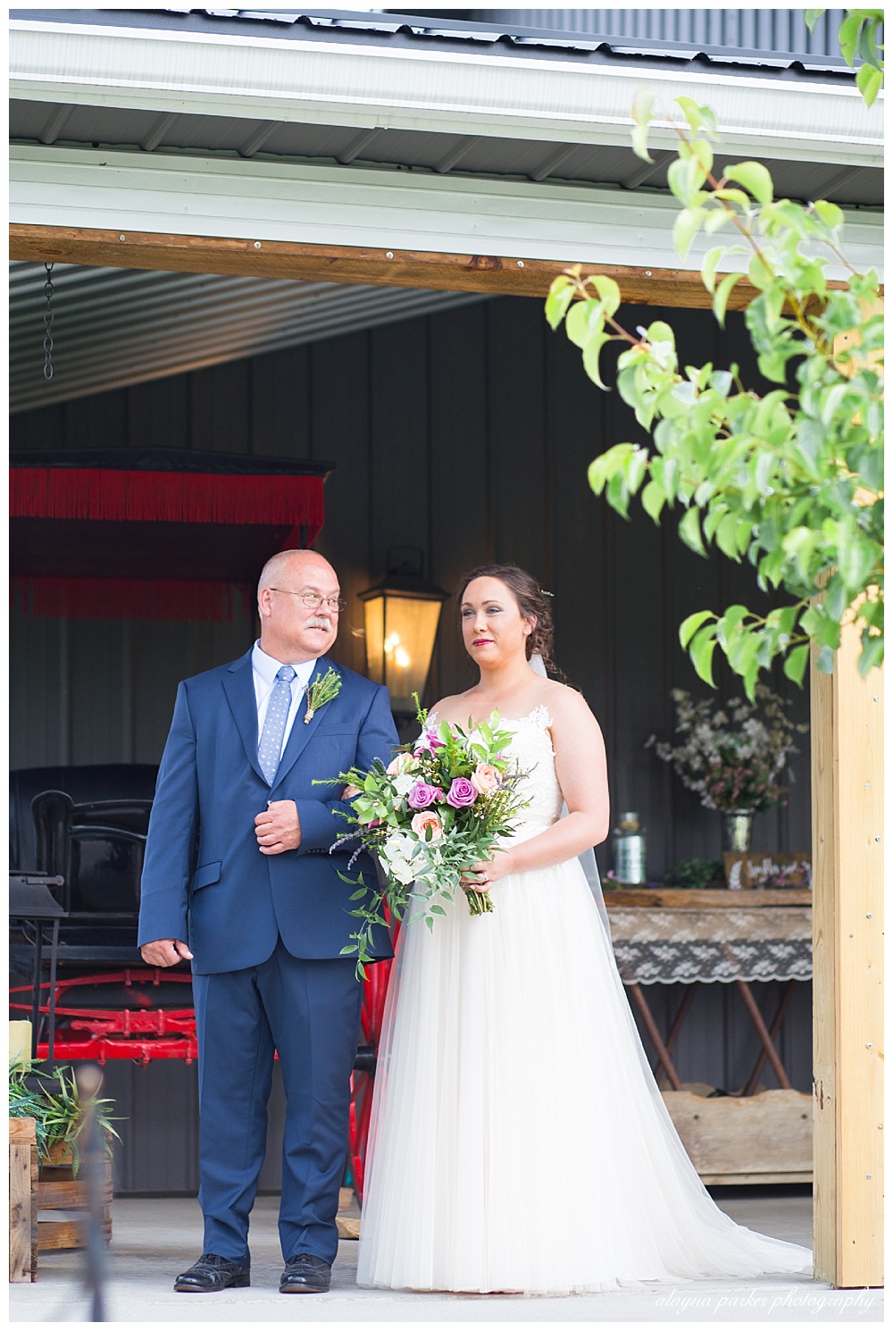 father looking at bride before walking down the aisle at the barn on enchanted acres