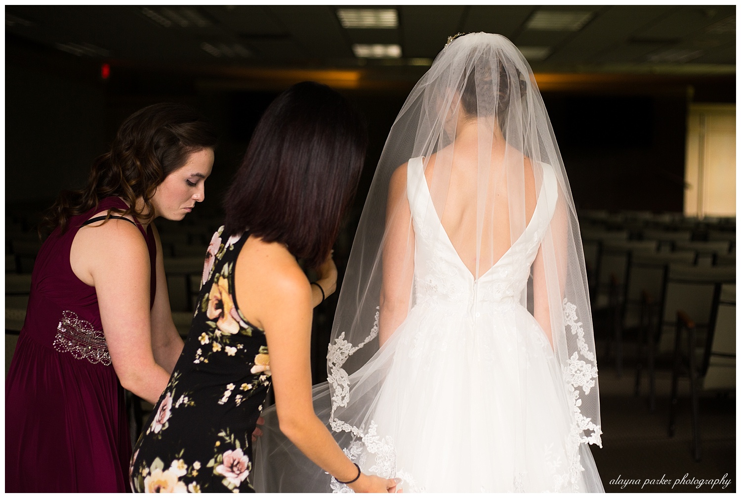 bridesmaids fixing brides veil