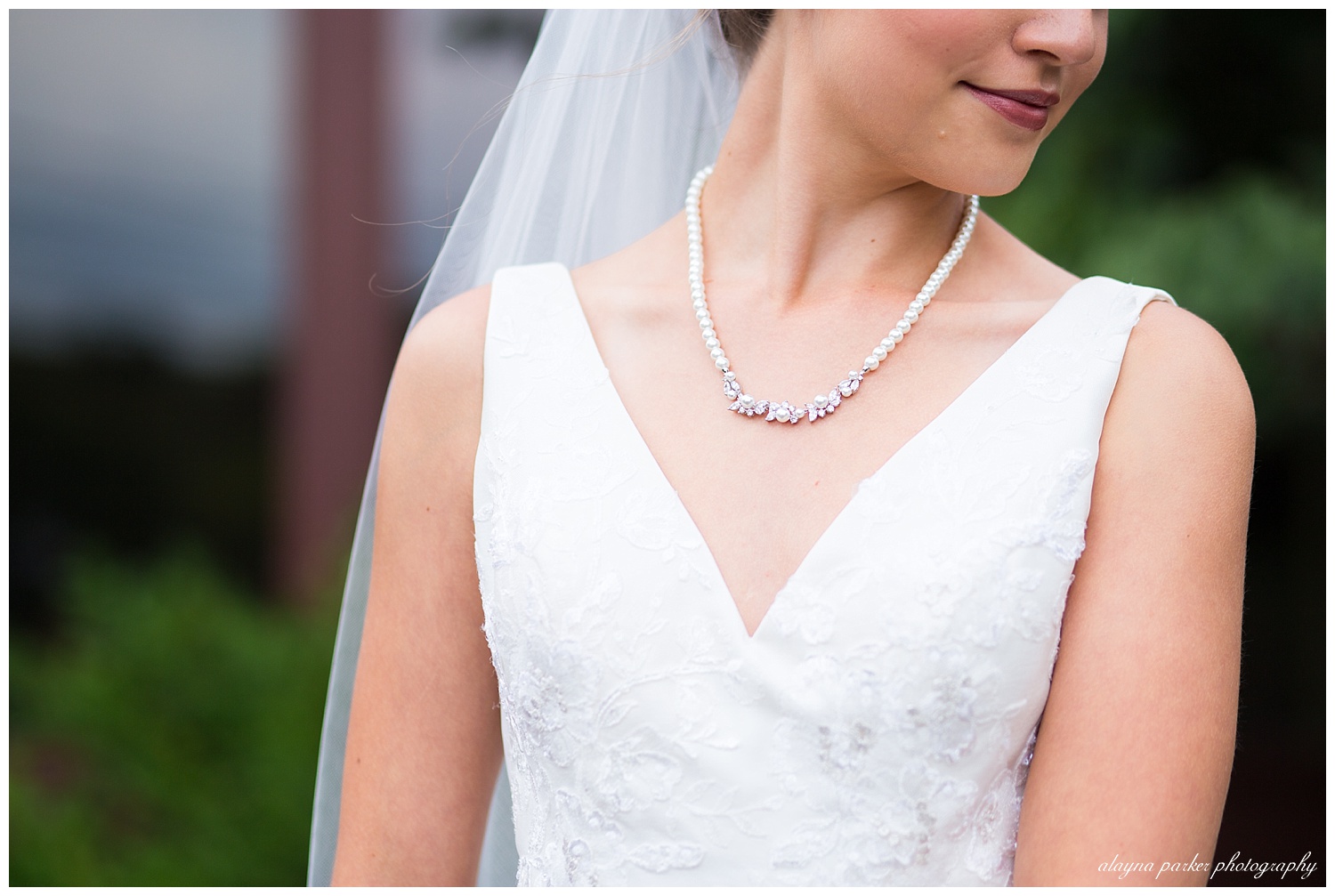 close up of bride wearing pearl necklace