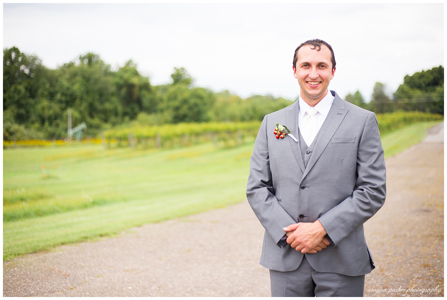 groom smiling at camera at sarah's vineyard