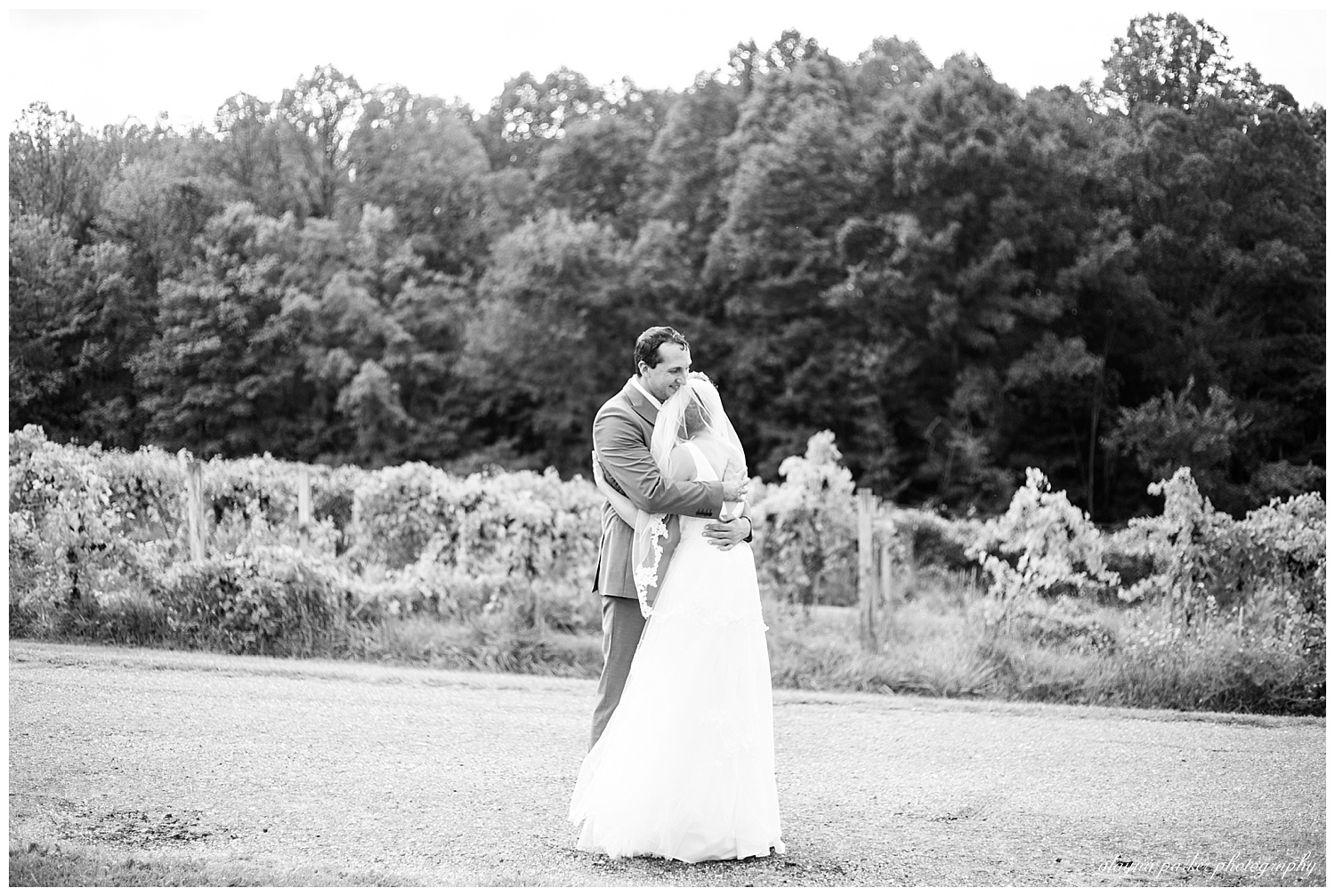 black and white image of bride and groom hugging after first look at sarah's vineyard