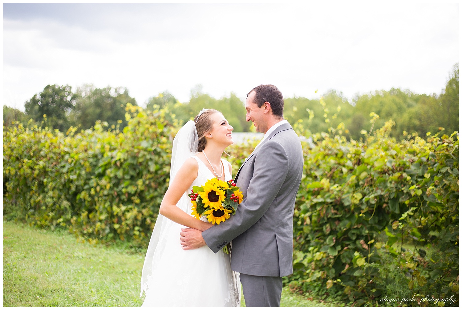 bride and groom laughing at each other at sarah's vineyard