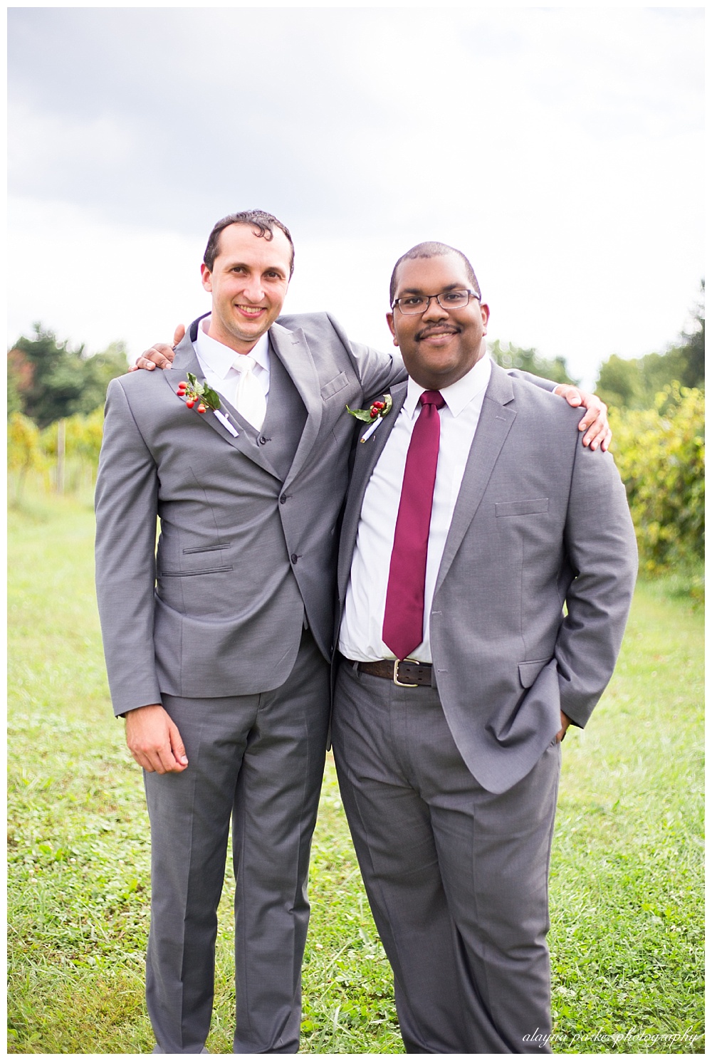 groom and groomsman wearing gray suits