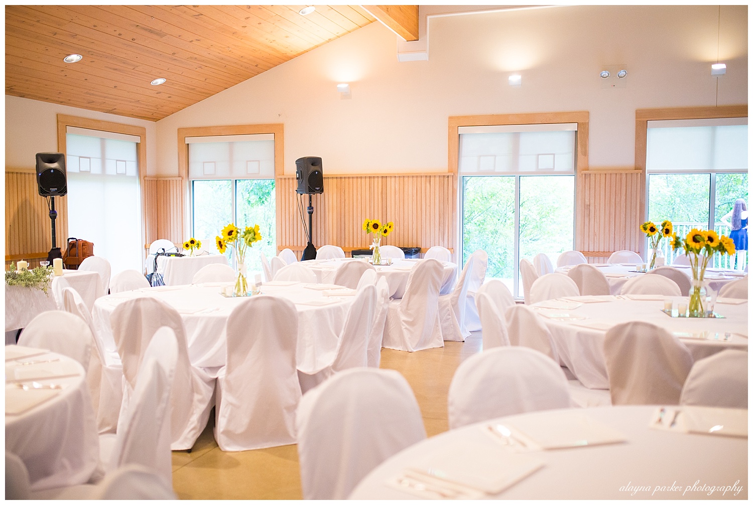 white tables and white chairs at coventry oaks pavilion wedding reception