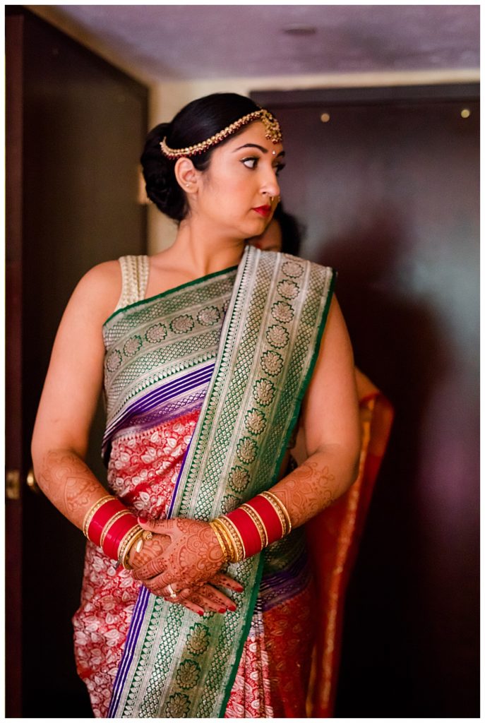 bride getting dressed in saree