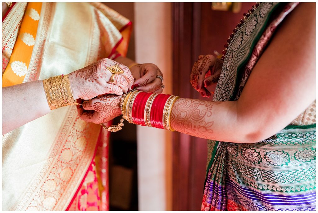 indian bride getting dressed for wedding