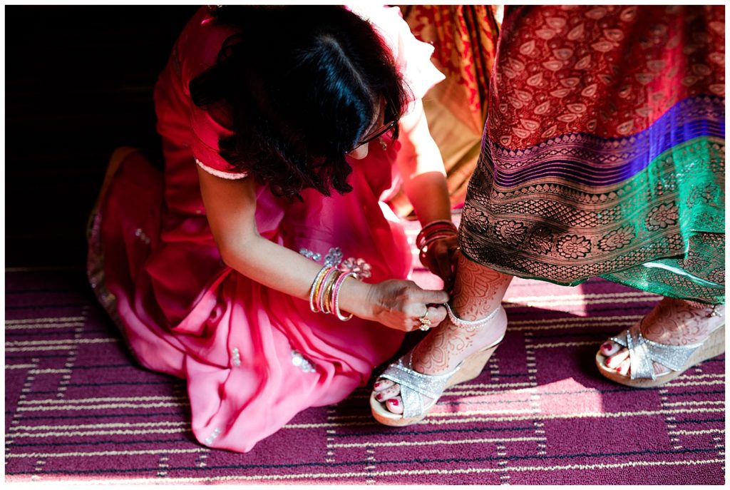indian bride getting dressed for wedding