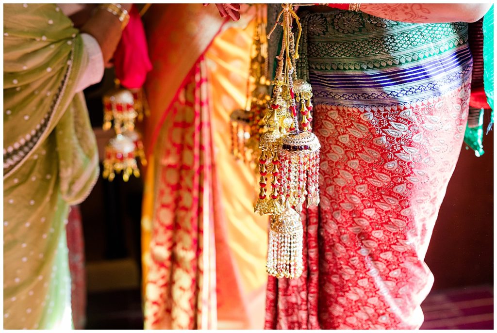 older indian women helping bride get dressed