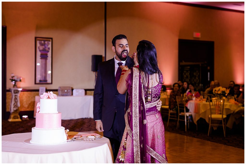 bride feeding groom cake at bertram inn