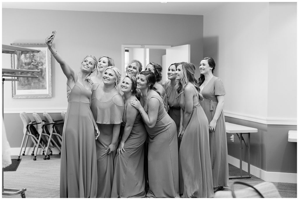 black and white image of bridesmaids taking selfie together