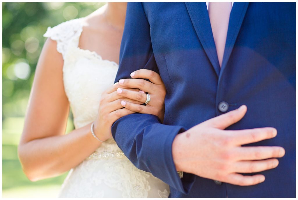 close up of bride's hands holding onto groom