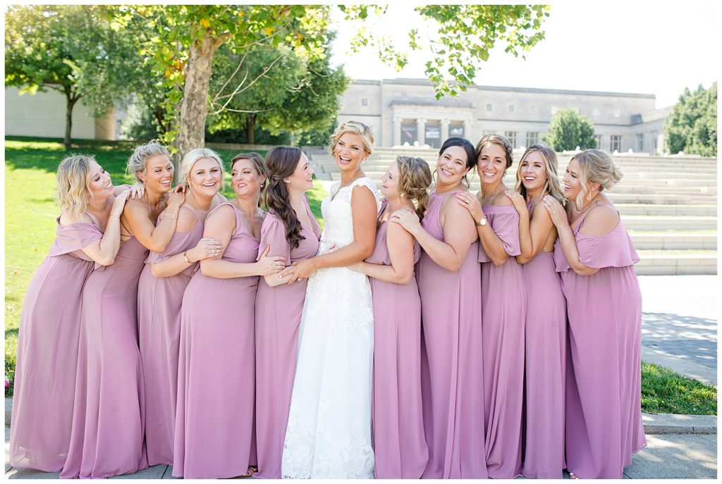 bride and bridesmaids laughing in front of steps at cosi