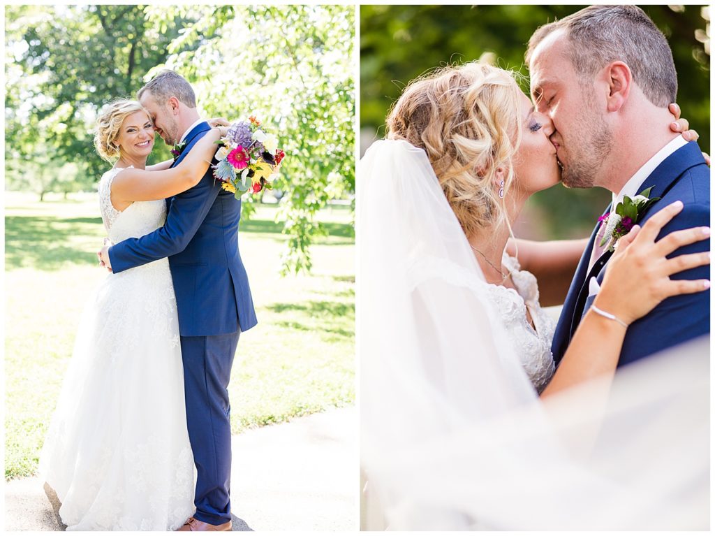 bride and groom kissing while veil blows in wind