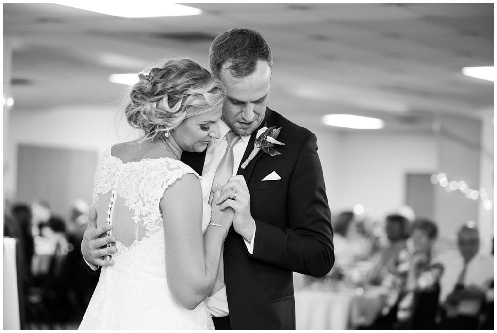 black and white image of bride and groom sharing first dance