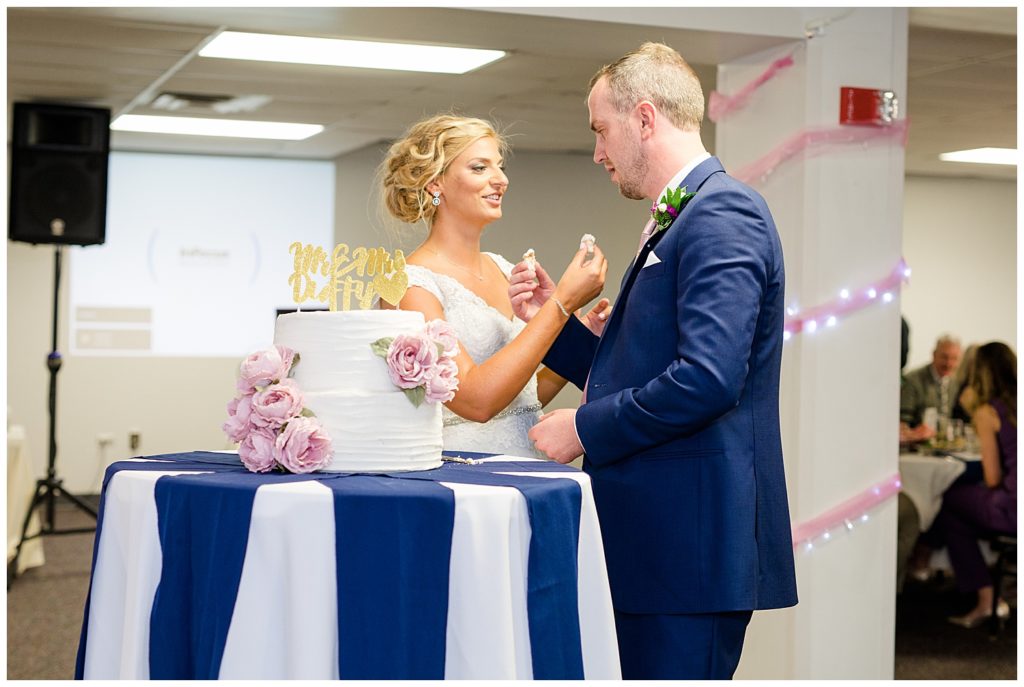 bride and groom feeding each other cake