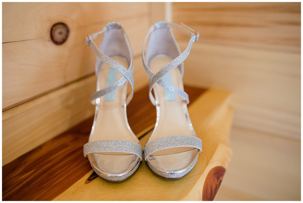 An image of a closeup view of the bride's beautiful silver shoes at the Cedar Grove Lodge venue in Hocking Hills, Ohio by Columbus Ohio wedding photographer, Alayna Parker Photography