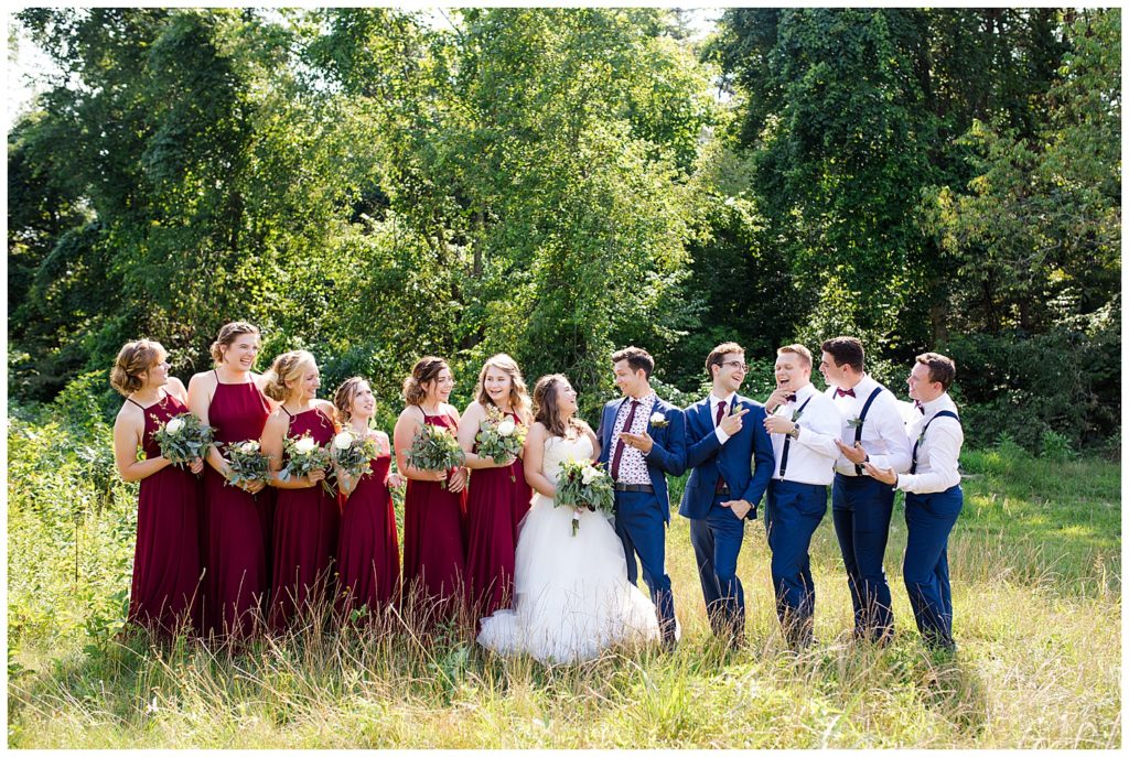 bridal party laughing in field at cedar grove lodge