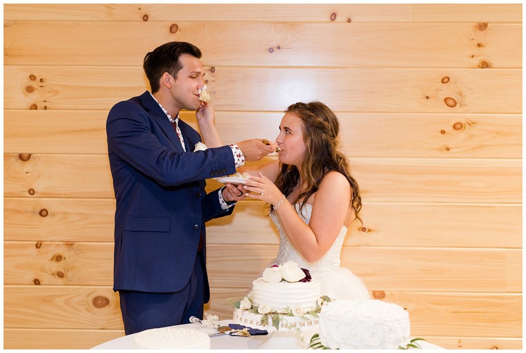 bride smashing cake in groom's face at cedar grove lodge