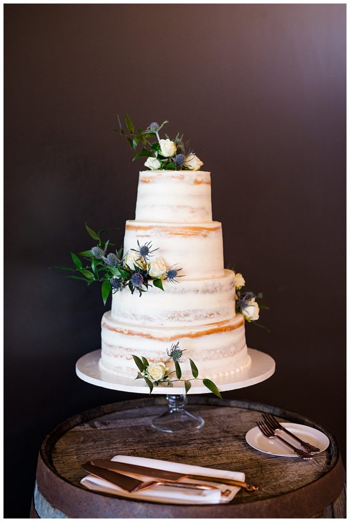 A photograph of a closeup view of the beautiful wedding cake at the wedding reception at the Oak Grove venue in New Albany, Ohio by Columbus OH wedding photographer, Alayna Parker Photography
