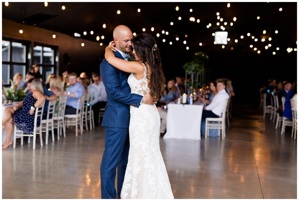 A photograph of the bride and groom romantically dancing their first dance at the wedding reception at the Oak Grove wedding venue by Columbus OH wedding photographer, Alayna Parker Photography
