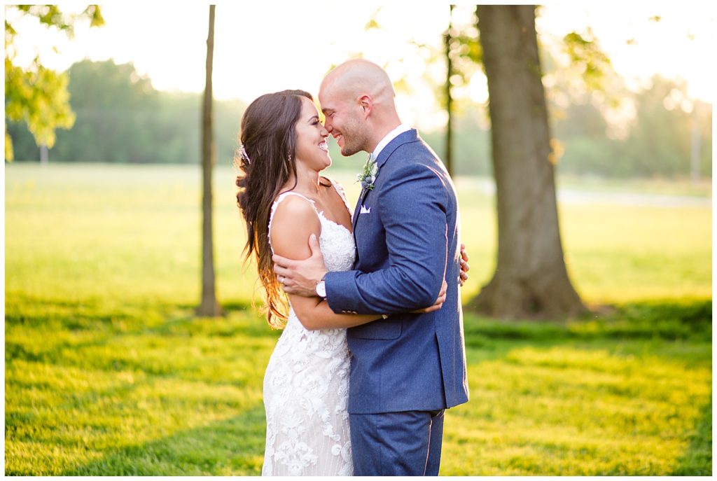 bride and groom smiling at each other during golden hour at jorgensen farms oak grove