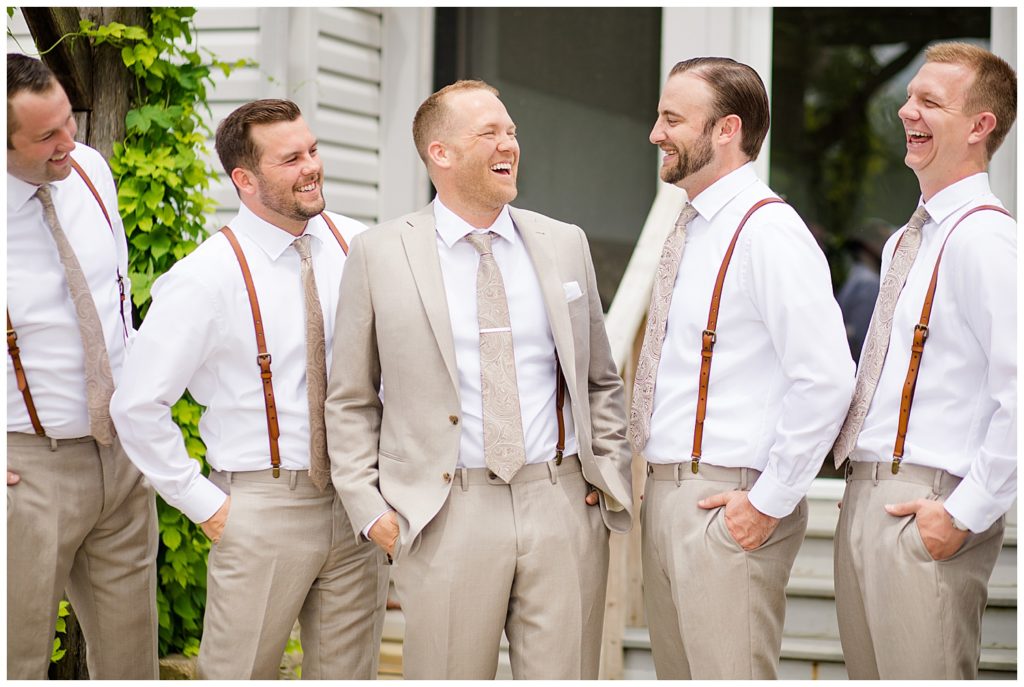 groom and groomsmen laughing at jorgensen farms